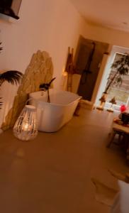 a bath tub sitting on the floor in a room at Coco Suite in Amay