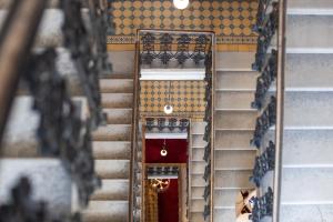 a set of stairs with a red door at Small Luxury Hotel Altstadt Vienna in Vienna