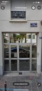 a building with glass doors with a car parked inside at Chat rose in Charenton-le-Pont