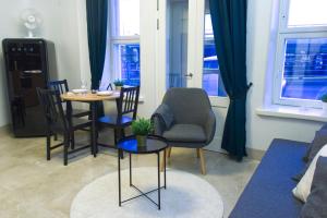 a living room with a table and chairs at Chic Studio in Historic Kruununhaka, Helsinki in Helsinki