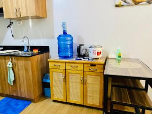 a kitchen with a bottle of water on the counter at Studio at The Loop in Camaman