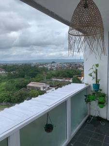 a white balcony with a view of a city at 2BR VIVO Apartement by MJP in Yogyakarta