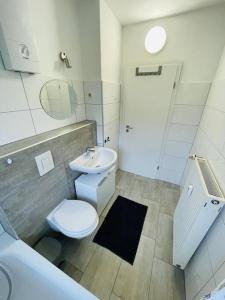 a bathroom with a toilet and a sink at Ferienwohnung in Herscheid in Herscheid