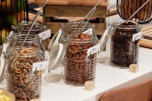 a group of jars filled with nuts on a table at Crowne Plaza - Marseille Le Dôme in Marseille