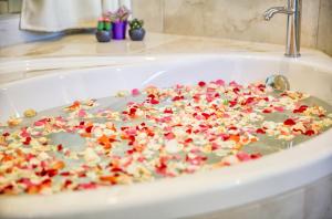 uma banheira cheia de confetes em Alia Luxury Beachfront Suites and SPA em Haraki