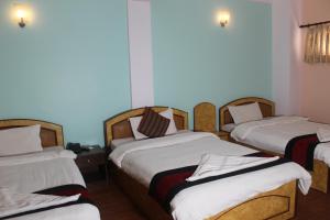 Postel nebo postele na pokoji v ubytování Hotel Happy Home or Mudkhu Durbar