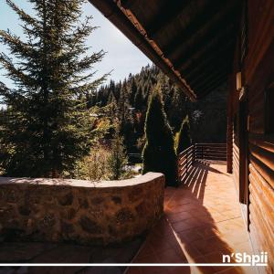 a porch of a house with a tree in the background at N'SHPII VILLA in Peje
