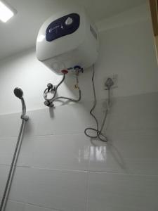 a blow dryer sitting on top of a white floor at Creek View Inn in Nuwara Eliya