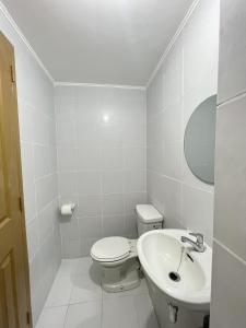 a white bathroom with a toilet and a sink at New 8 Spatial Davao Smart Studio Unit Netflix Wi-Fi Amazon Voice Controlled Lights in Davao City