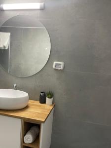 a bathroom with a sink and a mirror at K.suites סוויטות בוטיק in Bet Sheʼan