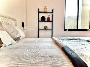 a bedroom with a bed and a window and a shelf at King's Landing for Pets in Karjat