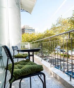 a balcony with a table and chairs and a view of a street at EN 6 #Studio City Heart in Thessaloniki