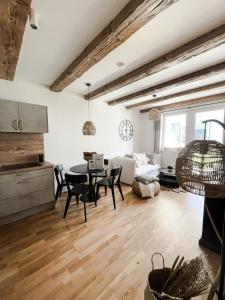 a kitchen and living room with a table and chairs at Bergzeit by Alpenidyll Apartments in Aich