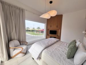 a bedroom with a bed and a large window at Nad Al Sheba 3 - 5BR Villa - Allsopp&Allsopp in Dubai