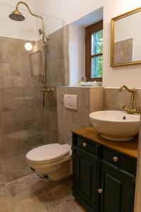 a bathroom with a toilet and a sink and a shower at Chillinn Rosé Cottage Eger in Eger +42 photos