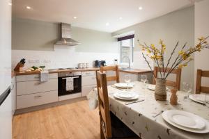 a kitchen with a table with plates on it at Wagtail Cottage in Berwick-Upon-Tweed