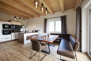 a kitchen and dining room with a table and chairs at Sonnendörfl in Poppendorf im Burgenland