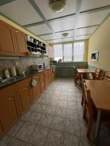 a kitchen with wooden cabinets and a table and chairs at Harrachov 624 in Harrachov