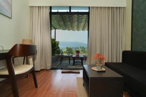 a living room with a large window with a view at Gaurav Lords Resort in Srīvardhan