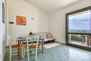 comedor con mesa y ventana en Libeccio Sea view house, en Badesi