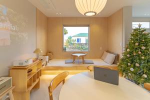 a living room with a christmas tree in the corner at Aewol Gilro in Jeju