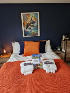 a bedroom with a bed with towels on it at Acarsaid B&B in Lybster