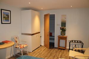 a small living room with a table and a kitchen at Level 15 Accommodation in Buxton