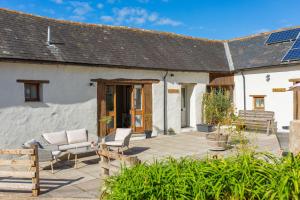 a patio in front of a white building at Putts Cottage in Braunton