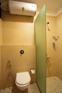 a bathroom with a toilet and a shower stall at Gaurav Lords Resort in Srīvardhan