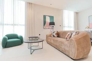 a living room with a couch and a table and a chair at Amber Hospitality - Al Nafel in Riyadh