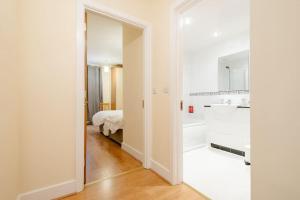 a white room with a bed and a bathroom at Peaceful 2 bedrooms near St Patrick's Cathedral in Dublin