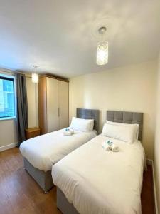 a hotel room with two beds and a window at Peaceful 2 bedrooms near St Patrick's Cathedral in Dublin
