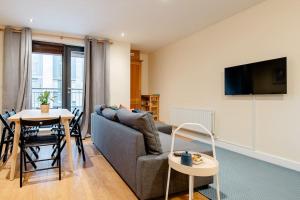 a living room with a couch and a table at Peaceful 2 bedrooms near St Patrick's Cathedral in Dublin