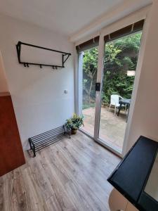 an empty room with a large sliding glass door at Cosy Studio with Garden Near the Prague Airport 