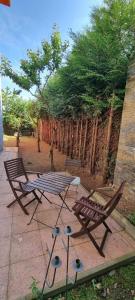 two chairs and a picnic table on a patio at Cosy Studio with Garden Near the Prague Airport 