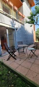 two chairs and a bench in front of a building at Cosy Studio with Garden Near the Prague Airport 