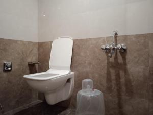 a bathroom with a toilet in a room at Hotel Raheja Residency in Mumbai