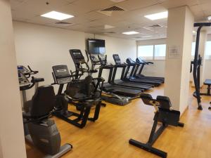 a gym with rows of treadmills and elliptical machines at Elite 6 Sports Residence by Golden Casa in Dubai