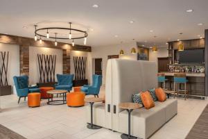 a lobby with chairs and a couch and a bar at Hilton Garden Inn San Antonio Downtown Riverwalk in San Antonio