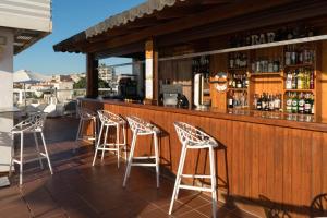 a bar with four stools sitting at a counter at Aluasun Lago Rojo - Adults recommended in Torremolinos