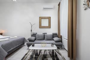 ein Wohnzimmer mit einem Sofa und einem Tisch in der Unterkunft Stellar Dwell Apartment in Budapest