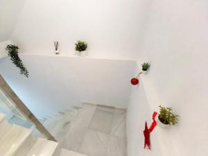 a room with a staircase with a person on the wall at Casa Malakita with private roof terrace - Brand new in Conil de la Frontera
