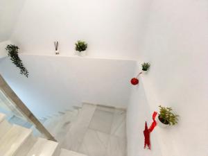 a room with a staircase with a person on the wall at Casa Malakita with private seaview roof terrace in Conil de la Frontera