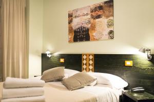 a bedroom with a bed with two pillows on it at Hotel Orvieto in Orvieto