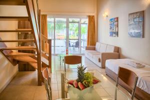 a living room with a couch and a table with fruit on it at Alia Apartments and Suites in Haraki
