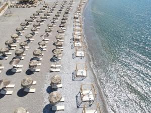 an aerial view of a beach with chairs and umbrellas at Alia Apartments and Suites in Haraki