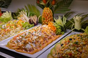 a buffet of different types of food on plates at HM Alma de Bayahibe - Adults Only in Bayahibe