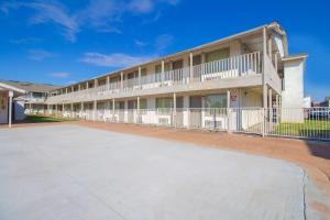 an empty parking lot in front of a building at Studio Inn Extended Stay Oklahoma City Airport by OYO in Oklahoma City