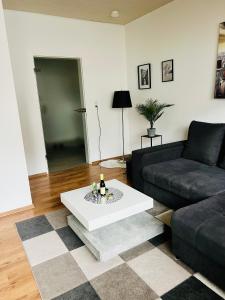 a living room with a couch and a coffee table at Kurstadt Apartment 2ZKB Balkon PKW Stlp-Self-Check-in in Bad Nauheim