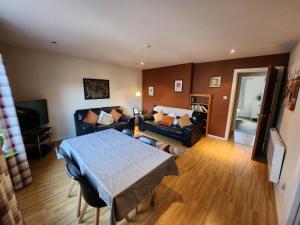 a living room with a couch and a table at Granite Getaways - Union Skyview in Aberdeen